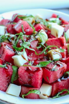 watermelon and cheese salad in a white bowl