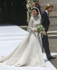 the bride and groom are walking down the aisle