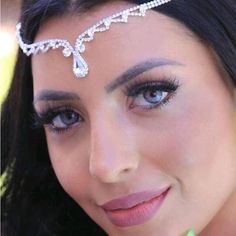 a woman wearing a tiara and smiling at the camera