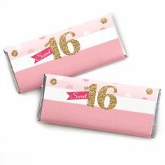 two pink and gold candy bar wrappers with glitter numbers on the top, one for sweet sixteen