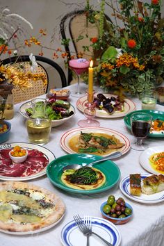 a table topped with plates and bowls filled with food