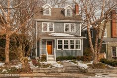 a house with snow on the ground and trees