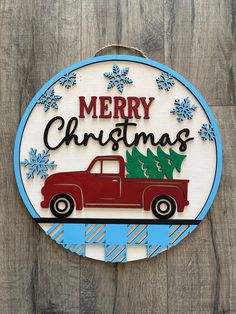 a merry christmas sign hanging on the side of a wooden wall