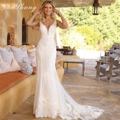 a woman in a wedding dress posing for the camera