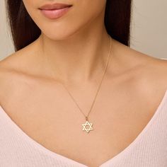 Our Large Star of David Pendant necklace features a hanging pendant handcrafted in 18-karat gold on a 18" link chain. A traditional symbol of Judaism and Jewish identity, this heirloom piece is a sweet gift for yourself or someone special and sure to be passed down through generations. Pendant hangs from 18", 14-karat link chain Pendant measures approximately 19.65mm x 16.75mm Spring ring clasp Made with love in Los Angeles Complimentary gift wrapping provided Sterling Silver Star Of David Necklace With Polished Finish, Elegant Star Charm Necklace, Tarnish Resistant, Elegant Star-shaped Tarnish Resistant Charm Necklace, Yellow Gold Star Of David Charm Necklace Gift, Yellow Gold Star Of David Charm Necklace, Yellow Gold Star Of David Necklace With Delicate Chain, Elegant Star Of David Hallmarked Necklace, Elegant Star Of David Anniversary Jewelry, Yellow Gold Charm Necklace With Star Of David Charm