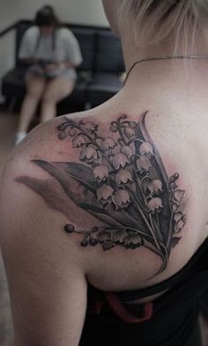 a woman with a flower tattoo on her back