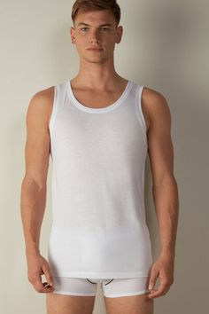 Crew neck tank top in 100% Extra-Fine SUPIMA® Cotton. Incredibly soft and breathable, this premium fiber offers excellent elasticity. The structure of the fabric means it will last wash after wash. A simple, comfortable style that's ideal for any occasion, whether worn as an undershirt or as an everyday shirt. White Classic Crew Neck Tank Top, White Seamless Crew Neck Tank Top, Classic Stretch Crew Neck Tank Top, Classic Solid Color Crew Neck Tank Top, White Crew Neck Tank Top For Layering, Scoop Neck Stretch Top For Daywear, Stretch Scoop Neck Top For Daywear, Casual Modal Tops With Seamless Construction, Classic Scoop Neck Solid Color Tank Top