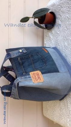 an old pair of jeans is hanging on the wall next to a purse and sunglasses