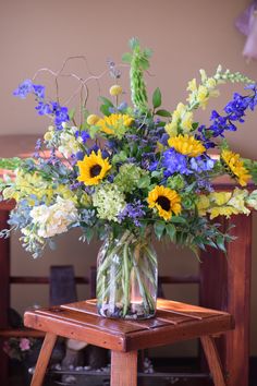 a vase filled with yellow and blue flowers