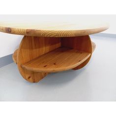 a wooden shelf sitting on top of a white floor