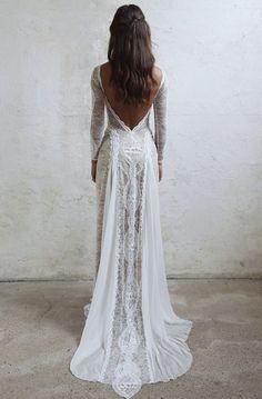 the back of a woman's wedding dress, with long sleeves and open shoulders