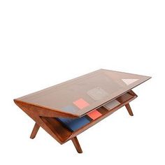 a wooden table with a glass top and three different colored sections on it's legs