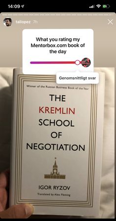 someone is holding up a copy of the kremlin school of negotation