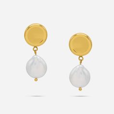 Experience a touch of elegance with our Ness Keshi Pearl Drop Earrings. Made with jewelry-grade stainless steel, these round mirrored stud earrings feature a dangling Keshi freshwater pearl. Elevate your style with these timeless and versatile earrings. Details: - Gold: 316L Stainless Steel, 18K Gold PVD Plated, Keshi Freshwater Pearls- Silver: 316L Stainless Steel, Keshi Freshwater Pearls Classic Metal Earrings With Pearl Charm, Classic Metal Pearl Earrings With Pearl Charm, Modern Pearl White Earrings With Pearl Drop, Modern Pearl White Earrings With Pearl Charm, Modern Pearl Charm Earrings, Minimalist Metal Pearl Drop Earrings, Modern Pearl Earrings With Pearl Charm, Timeless Round Pearl Drop Earrings, Timeless Round Pearl Pendant Earrings