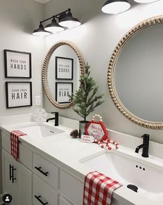 a bathroom decorated for christmas with holiday decorations on the vanity and mirror above it,