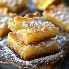 several pieces of pineapple sitting on top of a cutting board covered in powdered sugar