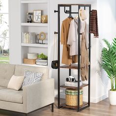 a living room filled with furniture and a coat rack