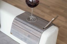 a glass of wine sitting on top of a wooden box