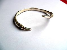 Bird talon claw cuff silver bracelet Silver Brass Bracelets Hand Cast, Gold Bracelet With Oxidized Finish As A Gift, Hand Cast Brass Bangle Bracelet, Hand Cast Brass Bangle Bracelets, Gold Cuff Bracelet With Oxidized Finish Gift, Gold Oxidized Finish Cuff Bracelet Gift, Silver Hand Cast Brass Cuff Bracelet, Elegant Claw-shaped Metal Jewelry, Gold Bangle With Oxidized Finish For Gift