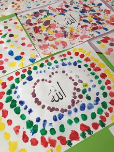 four different colored papers with arabic writing and polka dot designs on them, all in various colors