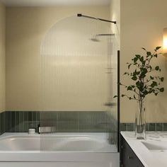 a bathroom with two sinks and a bathtub next to a shower head mounted on the wall