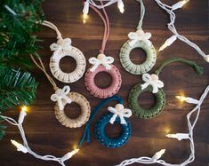 christmas lights and ornaments are arranged on a wooden surface with string lights strung around them