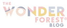 the wonder forest logo is shown on a white background with orange and blue letters that read,