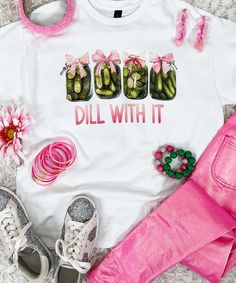 Introducing our "Dill With It Graphic Tee," a fun and quirky addition to your casual wardrobe. Available in sizes YXS through 5XL, this tee features the playful phrase "Dill with it" alongside four pickle jars adorned with cute pink bows, capturing the whimsical spirit of dill pickles in a unique and stylish way.
Crafted from high-quality, soft materials, this tee ensures all-day comfort, making it perfect for any casual outing, fun gatherings, or simply adding a touch of humor to your everyday wear. The "Dill With It Graphic Tee" is a versatile piece that adds a lighthearted flair to your style.
Embrace your love for dill pickles and spread some cheer with this delightful graphic tee. Whether you're enjoying a picnic, hanging out with friends, or just running errands, our "Dill With It Gr Funny Print Graphic Tee For Day Out, Party Graphic Tee With Funny Print, Spring Funny Print Graphic Tee, Graphic Tee With Funny Print In Ring-spun Cotton, Multicolor Funny Print Graphic Tee, Black Friday Christmas, Dill Pickles, Pickle Jars, Monogram Shirts