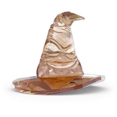 a glass figurine sitting on top of a plate with an upside down design