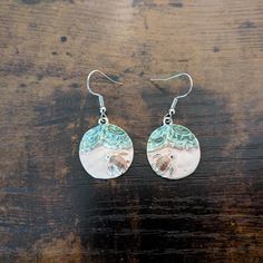 These lovely earrings are made with metal alloy pendants and nickel-free ear wires. Dangle length is approximately 1 inch, not including ear wires. To extend the life of your earrings, avoid contact with sweat, lotions, and other chemicals. Please message me with any questions. To see other earring options, check out my full store: https://www.etsy.com/shop/shopcraftyoctopus/ Round Metal Earrings For Beach, Round Metal Earrings For The Beach, Beach Earrings, Green Jewelry, Knoxville Tn, Lovely Earrings, Rose Earrings, Circle Earrings, Beach Sand