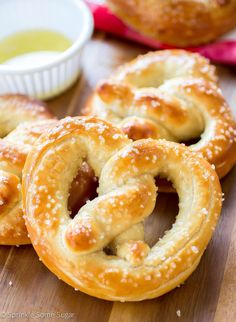 some pretzels are sitting on a table with dipping sauce