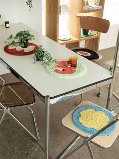 two plates with plants on them are sitting on a table in the middle of a room