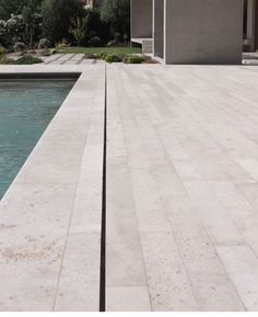 an empty pool in front of a house