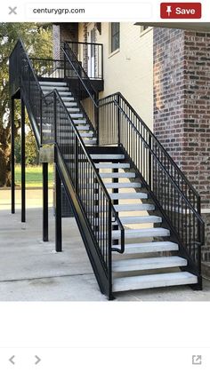 a set of stairs leading up to a brick building with white steps and railings