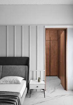 a bedroom with marble flooring and white walls