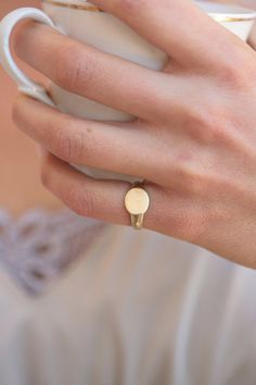 A classic signet ring for women. A dainty 14K yellow gold signet ring. This ring will be especially beautiful as a pinky ring will look great on any finger you choose to wear it. The ring is not hollowed and has a shiny finish, also on the inside. #signetring #goldring #studiounkiya Dainty Yellow Gold Signet Ring For Everyday, Simple 14k Gold Engraved Ring For Anniversary, Simple Gold Engraved Promise Ring, Dainty Engraved 14k Gold Ring, Minimalist Hallmarked Dome Ring For Everyday, Dainty 14k Stamped Signet Ring For Everyday, Dainty Everyday 14k Stamped Signet Ring, Dainty 14k Gold Signet Ring For Everyday, Dainty Open Signet Ring For Anniversary