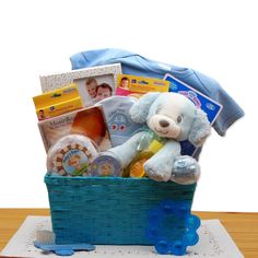 Sure to pamper the new baby boy and please the proud new parents, this gift basket shows how much you care. Every new Baby boy needs his first puppy love. This ultra plush and oh so cute puppy is eagerly awaiting to become the new baby boy's best friend. We've included a footprint kit with a puppy theme, first tooth and curl keepsake box also in a puppy theme as well as all the new baby essentials the proud parents could need. The Puppy Love New Baby Gift Basket - Blue includes: Ultra soft plush My First puppy, footprint kit with a puppy theme, first tooth and curl keepsake box also in a puppy theme, baby lullaby CD, baby manicure set, baby brush and comb set, Johnson & Johnson Baby Shampoo, baby gel teether, baby photo frame, baby beanie, baby bodysuit, blue hamper. This gift measures 12" New Baby Gift Basket, Pink Gift Basket, First Puppy, Baby Boy Hamper, Thoughtful Baby Gifts, Baby Boy Gift Baskets, Welcome New Baby, Baby Lullabies, Baby Photo Frames