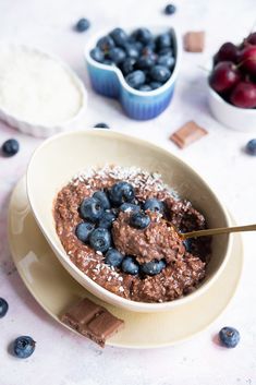 a bowl filled with chocolate pudding and blueberries