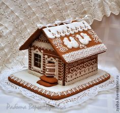 a gingerbread house is on a doily