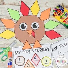 a turkey cut out with scissors and markers on a wooden table next to some crayons