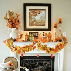 a fireplace decorated with fall leaves and pumpkins