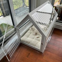 a dog bed in the corner of a window sill next to a sliding glass door