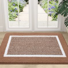 a door mat in front of an open window