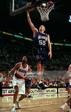 a basketball player jumping up to dunk the ball