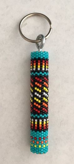 a beaded keychain is hanging on a white surface