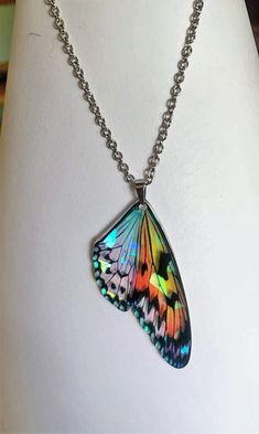 Beautiful holographic monarch butterfly pendant suspended on your choice of a stainless steel 16-19inch cable chain or an 18 inch black jewelry cord. both with a lobster clasp closure.  As seen in the photos, the butterfly wings take on different colors depending on the light that is reflected on the many facets and the pendant is 1/16 of an inch thick acrylic and very light weight.  Your necklace will arrive in a gift box.  To see the Fairy wing necklaces, or matching butterfly earrings please visit out shop by clicking this link; https://lacostaskreations.etsy.com Adjustable Metal Butterfly Necklace For Gifts, Adjustable Metal Butterfly Necklace Gift, Adjustable Multicolor Butterfly Jewelry, Multicolor Adjustable Butterfly Necklace For Gift, Adjustable Multicolor Butterfly Necklace Gift, Adjustable Multicolor Butterfly Necklace For Gift, Iridescent Butterfly-shaped Jewelry Gift, Iridescent Butterfly Jewelry For Gifts, Iridescent Butterfly Shaped Jewelry Gift