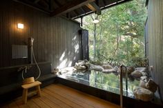 an indoor jacuzzi with rocks and water in it