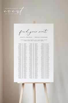 an easel with a wedding seating chart on it