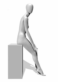 a white mannequin sitting on top of a box