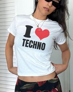 I Heart Techno Baby Tee Making a comeback being one of the most iconic trends of the '90s and early 2000's is the one and only baby tee. Make a nostalgic fashion statement by rocking this baby tee fit with whatever outfit you desire, picking a true to size fit will allow for a relaxed look or size down for that popular cropped fit, a perfect mixture of quality and comfort✨ About the product: 100% cotton for solid colour print Fit with a crew neckline for a timeless fashionable look Tear-away lab Baby Tees 90s, Nostalgic Fashion, Bebe T Shirt, Graphic Baby Tee, Y2k Crop Top, Trendy Crop Tops, 90s Tees, Baby Graphic Tees, Baby Tees Y2k